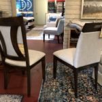 A furniture store with chairs in the forefront.