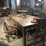 A wood table and chairs in a restaurant.