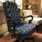 A traditional black leather office chair.